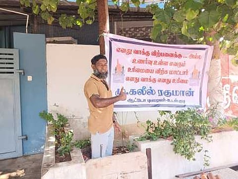 The auto driver Kaleel Rahman of Udangudi with a flex banner raised in front of his house to create awareness about desisting from cash for votes
