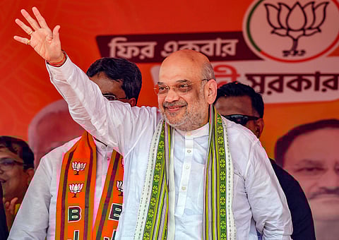 Union Home Minister and BJP leader Amit Shah waves at supporters during a public meeting, ahead of Lok Sabha elections, in Kumarghat, Tripura, Monday, April 15, 2024.