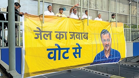 AAP workers put up posters in support of jailed party supremo Arvind Kejriwal