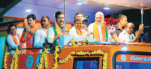 Union Home Minister Amit Shah holds a roadshow in Channapatna, ahead of the Lok Sabha polls, on Monday.