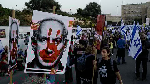 People take part in a protest against Israeli Prime Minister Benjamin Netanyahu's government and call for the release of hostages held in the Gaza Strip by the Hamas militant group outside of the Knesset, Israel's parliament, in Jerusalem, Sunday, March 31, 2024.