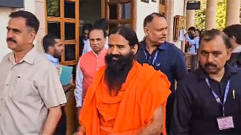 Yoga guru Ramdev arrives at the Supreme Court for hearing on the Patanjali misleading advertisements case, in New Delhi.