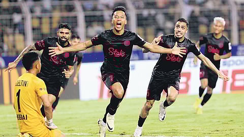 Lallianzuala Chhangte (C) wheels away in celebration after scoring against Goa