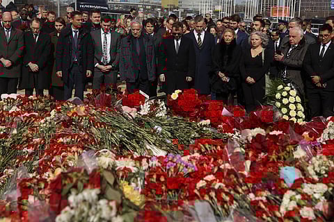 Ambassadors and representatives of diplomatic missions accredited in Russia stand at attention as they attend a flower laying ceremony at the memorial in memory of the victims of the terrorist attack at the Crocus City Hall concert venue a week after the attack in Krasnogorsk, outside Moscow on March 30, 2024.