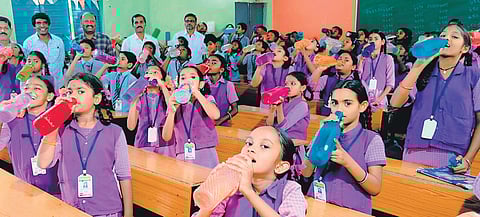 Students seen hydrating themselves during ‘water-bell’ at ZPHS at Sambepalli in Annamayya district