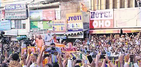 PM Narendra Modi, UP CM Yogi Adityanath and BJP candidate Atul Garg during the roadshow in Ghaziabad on Saturday