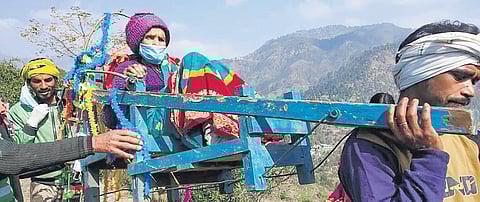 A handicapped voter being carried to a polling booth during Uttarakhand state polls