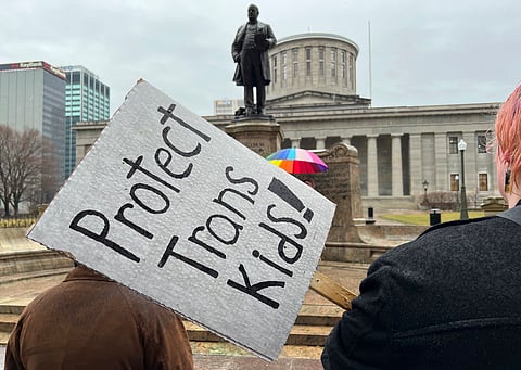 Demonstrators advocating for transgender rights and healthcare stand outside of the Ohio Statehouse on Jan. 24, 2024, in Columbus, Ohio.