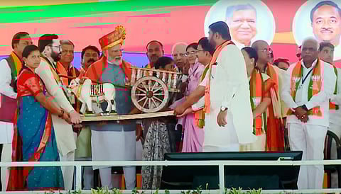 Prime Minister Narendra Modi being presented a memento during a public meeting for Lok Sabha polls, in Belagavi, Karnataka.