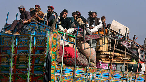 Afghan families onboard a truck head toward a border crossing point in Torkham, Pakistan,
