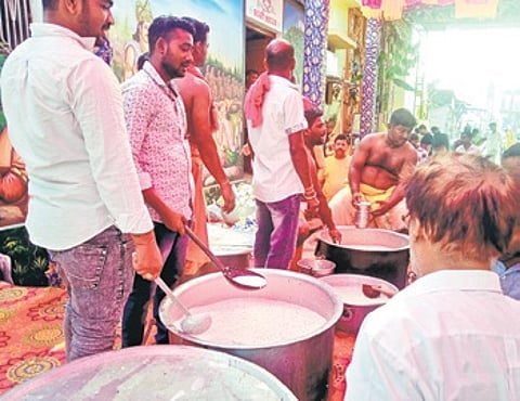 Pana being prepared to be distributed among people on the occasion of Mahabishuba Sankranti in Puri