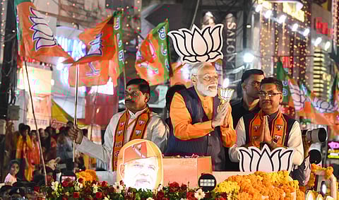 Prime Minister Narendra Modi with Madhya Pradesh Chief Minister Mohan Yadav and BJP candidate Ashish Dubey during a road show ahead of Lok Sabha elections, in Jabalpur, Sunday, April 7, 2024.