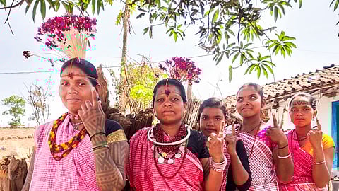 Baiga tribal women show their fingers marked with indelible ink after casting their votes for the first phase of Lok Sabha elections, in Dindori district in Madhya Pradesh