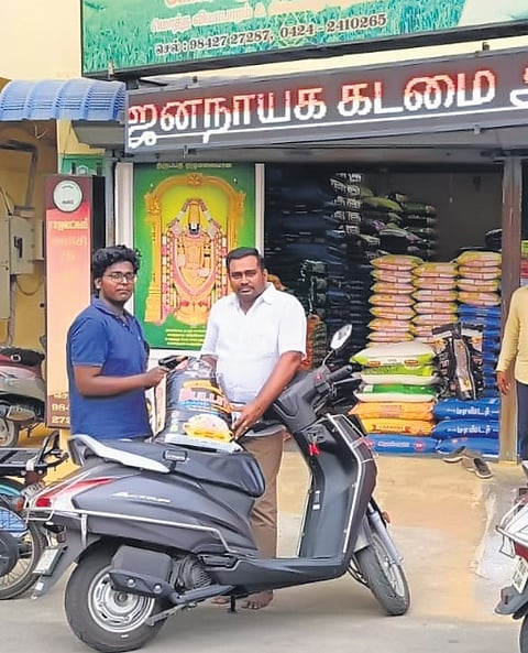 Shop owner P Saminathan selling rice bags at a discounted price to voters in Erode