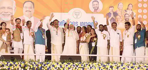 Prime minister Narendra Modi waving party workers during the election campaign at Kunnamkulam in Trissur on Monday.
