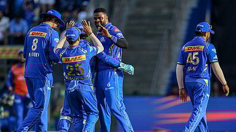 Mumbai Indians team players celebrate their win during the Indian Premier League cricket match between Mumbai Indians' and Delhi Capitals' in Mumbai.