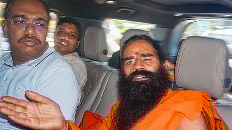 Yoga guru Ramdev (R) and Patanjali Ayurved MD Acharya Balkrishna (C)