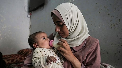 Rola Saqer feeds her baby Masa Mohammad Zaqout at her parents' home in the neighborhood of Zawaida, central Gaza, Thursday, April 4, 2024. Zaqout was born Oct. 7, the day the Israel- Hamas war erupted.