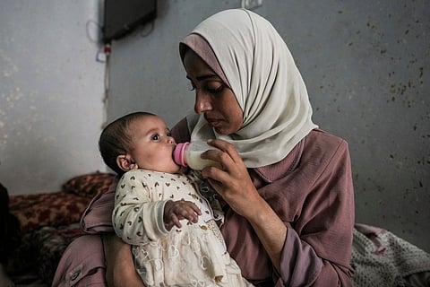Rola Saqer feeds her baby Masa Mohammad Zaqout at her parents' home in the neighborhood of Zawaida, central Gaza, Thursday, April 4, 2024. Zaqout was born Oct. 7, the day the Israel- Hamas war erupted.