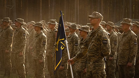 Newly recruited soldiers attend a ceremony as they celebrate the end of their training at a military base close to Kyiv.