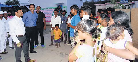 Palnadu district Collector Sivashankar Lotheti explaining the importance of adult franchise to tribals during ‘Palle Nidra’ programme