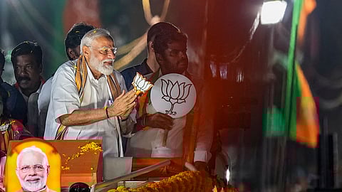 Prime Minister Narendra Modi greets supporters during a roadshow ahead of the Lok Sabha election, in Chennai, Tuesday, April 9, 2024.