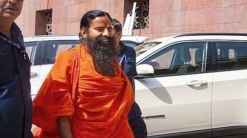 Yoga guru Ramdev arrives at the Supreme Court for hearing on the Patanjali misleading advertisements case, in New Delhi,