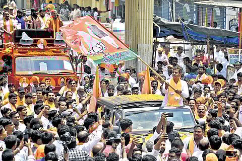 BJP Chevella candidate Konda Vishweshwar Reddy waves the party flag during
a rally in Rajendranagar on Monday.
