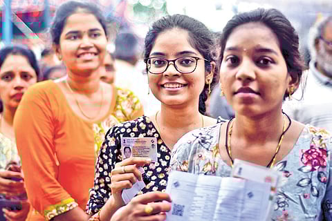First-time voters pose for a picture as they stand in queue to cast their vote in Undavalli on Monday
