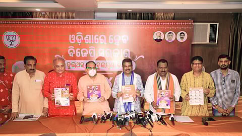 Dharmendra Pradhan releasing the BJP manifesto for Odisha at Sambalpur on Tuesday.