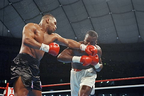 This file photo taken on February 11, 1990 shows US world heavyweight champion Mike Tyson (L) fighting against US challenger James Douglas (R) at the Tokyo Dome stadium in Tokyo.