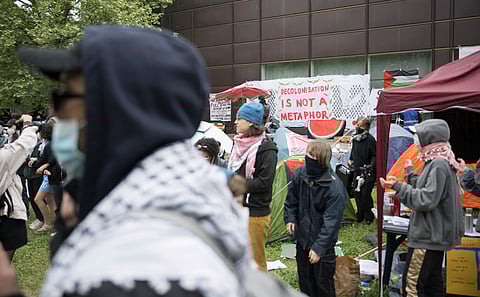Participants stand during a pro-Palestinians demonstration by the group 'Student Coalition Berlin' in the theater courtyard of the 'Freie Universität Berlin' university in Berlin, Germany, Tuesday, May 7, 2024.