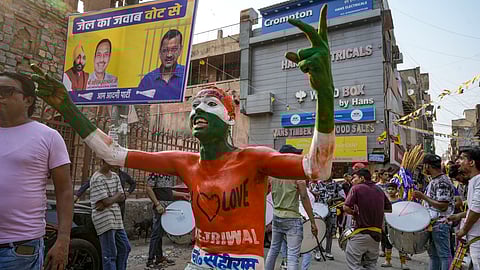 An AAP supporter during Delhi Chief Minister and AAP convenor Arvind Kejriwal's road show for Lok Sabha elections at Mehrauli in New Delhi, Saturday, May 11, 2024.