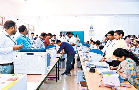 EVMs being checked at BJB College in Bhubaneswar; an elderly voter shows his inked finger after casting his vote from home in Bhubaneswar