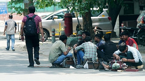 Coblers rest under a tree on a hot summer day, in New Delhi, Sunday, May 19, 2024.