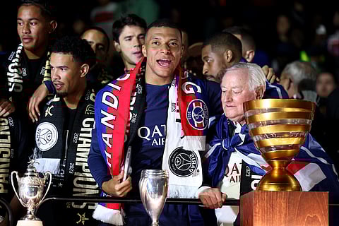 PSG's French forward Kylian Mbappe (C) celebrate with the French Ligue 1 championship's trophy during a ceremony following the French L1 football match between PSG and TFC on May 12, 2024.
