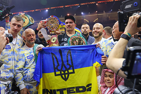 Ukraine's Oleksandr Usyk (C) celebrates his victory over Britain's Tyson Fury during a heavyweight boxing world championship fight at Kingdom Arena in Riyadh, Saudi Arabia on May 19, 2024.