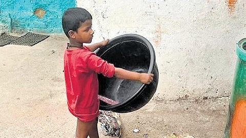 With water available for only two
hours a week, families in DJ Halli assert that tubs serve as toys since there is no water to store | Express