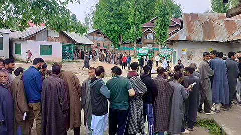 People wait in queues at a polling station to cast their votes during the fourth phase of Lok Sabha elections, in Jammu and Kashmir.