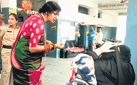 BJP candidate K Madhavi Latha seen talking to a voter waiting at a polling booth