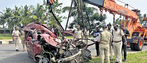 Police shifting a damaged car hit by a lorry in NTR district on Monday