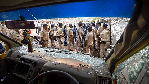 Police personnel outside a private school as it was torched by protestors after the body of a student was allegedly found on school premises in Patna.