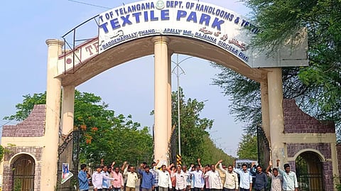 Power loom workers staged protest at Textile park in Sircilla on Friday.