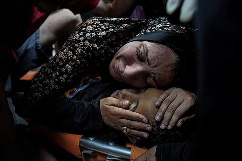 A Palestinian woman mourns her child, Mahmoud Essa 12, who was killed in the Israeli bombardment of the Gaza Strip, at Al Aqsa Hospital in Deir al Balah, early Sunday, May 12, 2024.