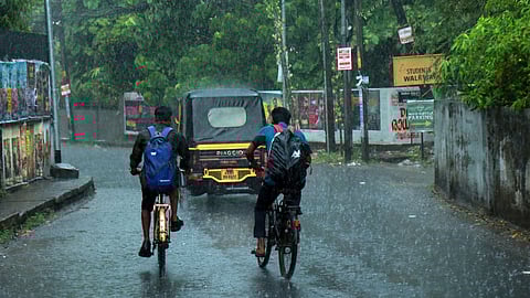 Cyclists speeding through a street near Kadavanthra as they were caught off guard in the rain that lashed Kochi.