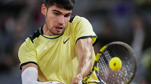 Carlos Alcaraz, of Spain, returns the ball to Andrey Rublev, of Russia, during the Mutua Madrid Open Tennis tournament in Madrid, Wednesday, May 1, 2024.