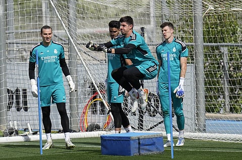 Real Madrid's goalkeeper Thibaut Courtois, 3rd left, trains watched by reserve goalkeeper Andriy Lunin, left, during a Media Opening day training session in Madrid, Spain, on May 24, 2022.