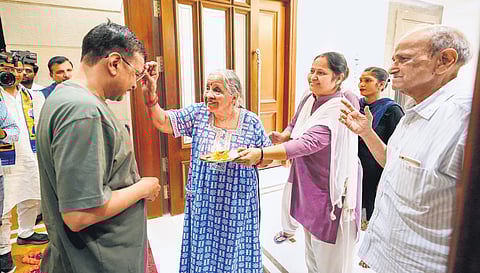 CM Arvind Kejriwal being greeted by family members at his official residence in New Delhi on Friday