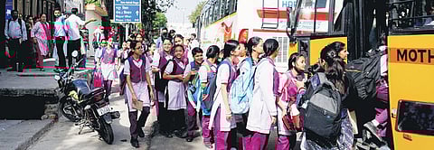 Students board a bus outside Mother Mary’s School in Mayur Vihar