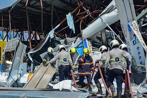 Fire Brigade personnel seen cooling the site of the hoarding collapse at Ghatkopar, in Mumbai, Tuesday, May 14, 2024.